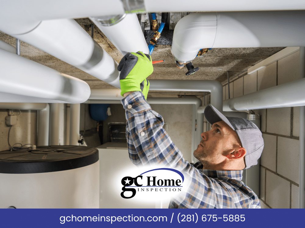 Inspector in work gloves checking plumbing supply lines and insulated pipes in a home's utility area