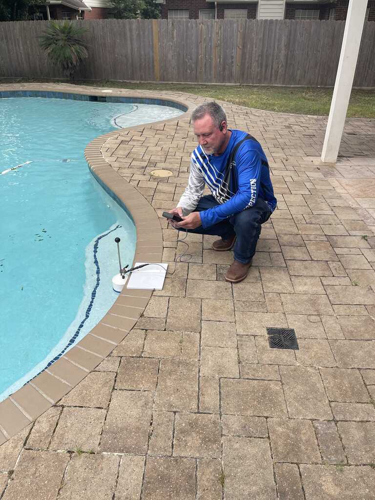 GC Home Inspection inspector measuring water loss during a pool leak detection at a Pearland TX backyard pool