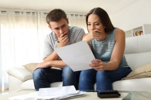 a couple thinking and holding a paper | GC Home Inspection | Insurance Pearland