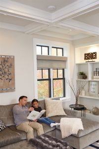 father and daughter reading book in living room | GC Home Inspection | carbon monoxide Pearland