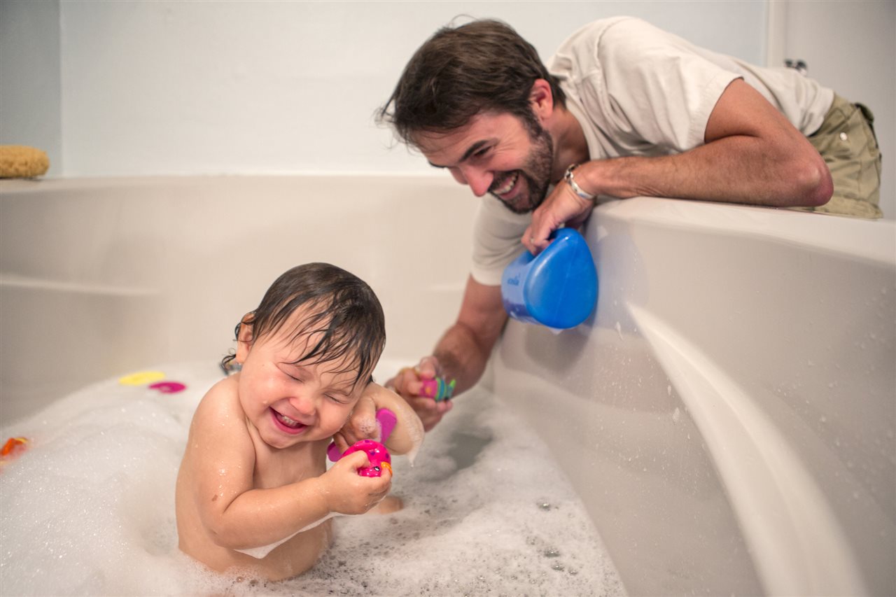a baby in an bathtub tickled by Daddy | GC Home Inspection | value-enhancing home improvement projects Pearland